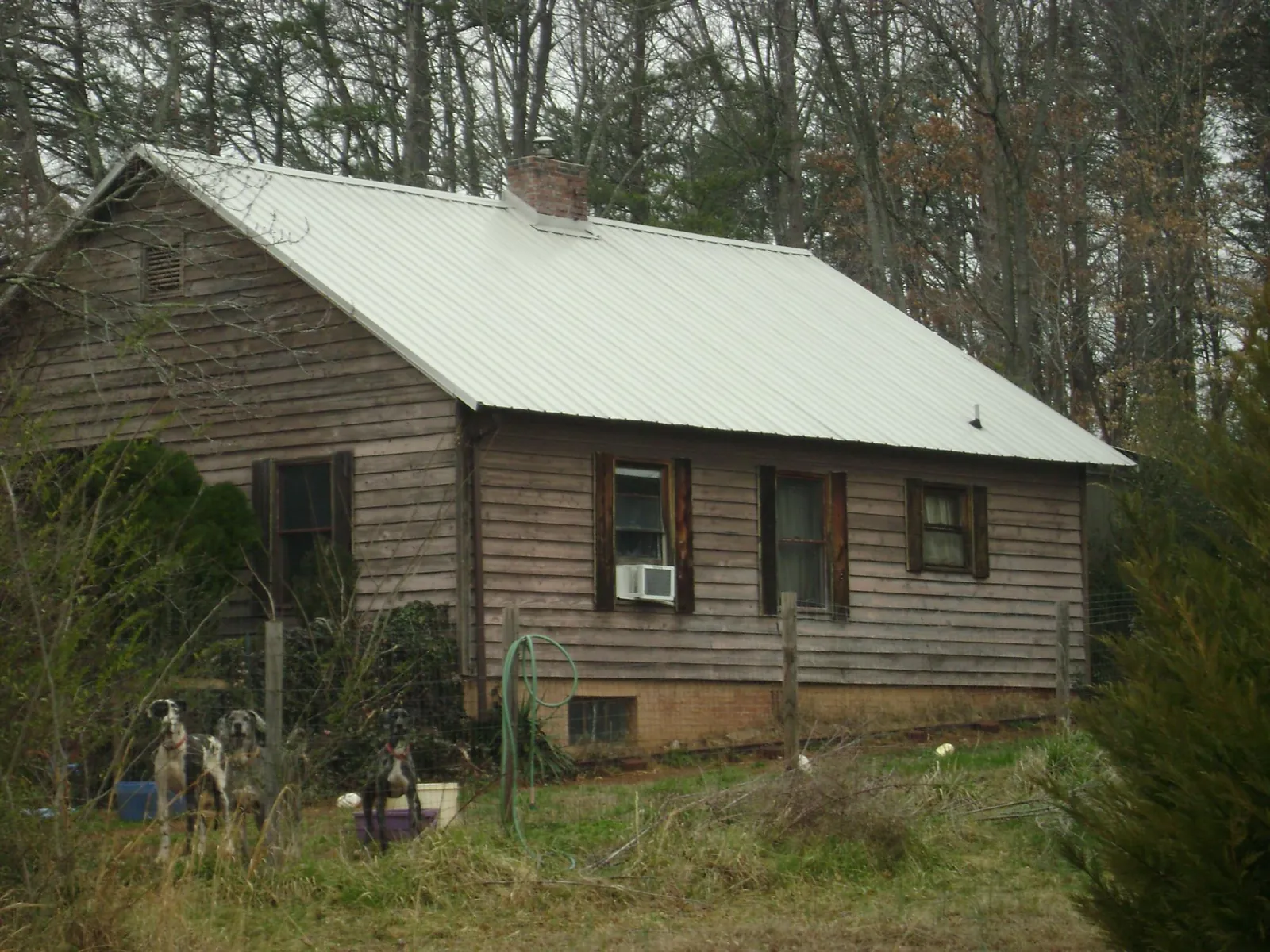 White metal roof on an old wood sided farmhouse, from a Metal Roof Installation job in Risingsun